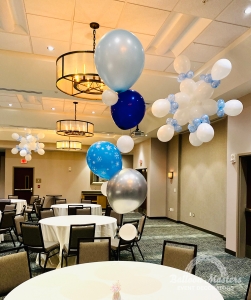 Snowflake balloons hung from ceiling, and winter themed balloon centerpieces