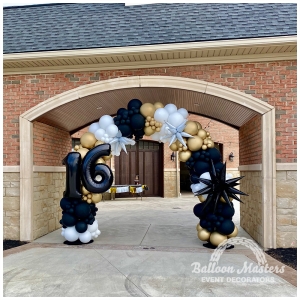 a black, gold, and white balloon arch with the numbers 16 on the side.