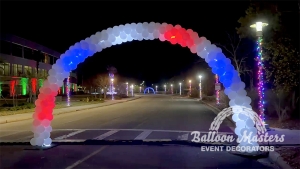 white balloon arch with led lights strung through creating a moving red white and blue moving effect.