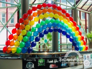 singular stands of arched colored balloons stacked creating a rainbow.