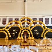 multiple gold balloon arches stacked to create a web formation of balloon arches.