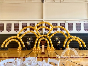 multiple gold balloon arches stacked to create a web formation of balloon arches.