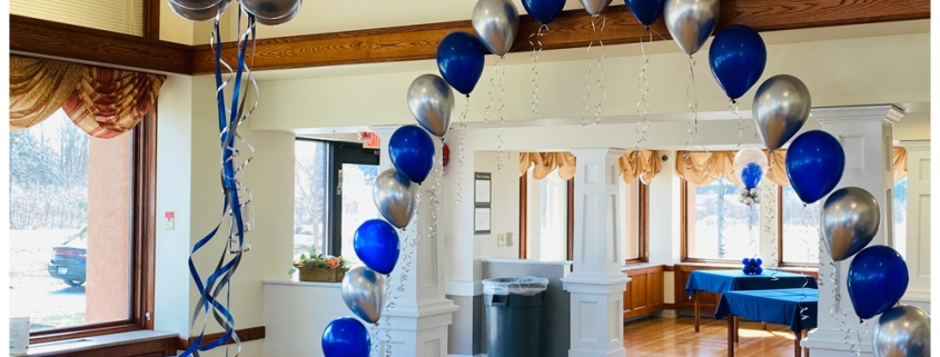 blue and silver balloons strung to make arch shape.