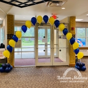 Yellow and blue balloons singularly strung to make arch shape.