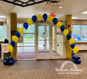 Yellow and blue balloons singularly strung to make arch shape.