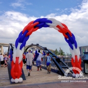 A red white and blue balloon arch.