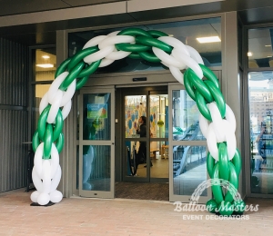 a green and white balloon arch.